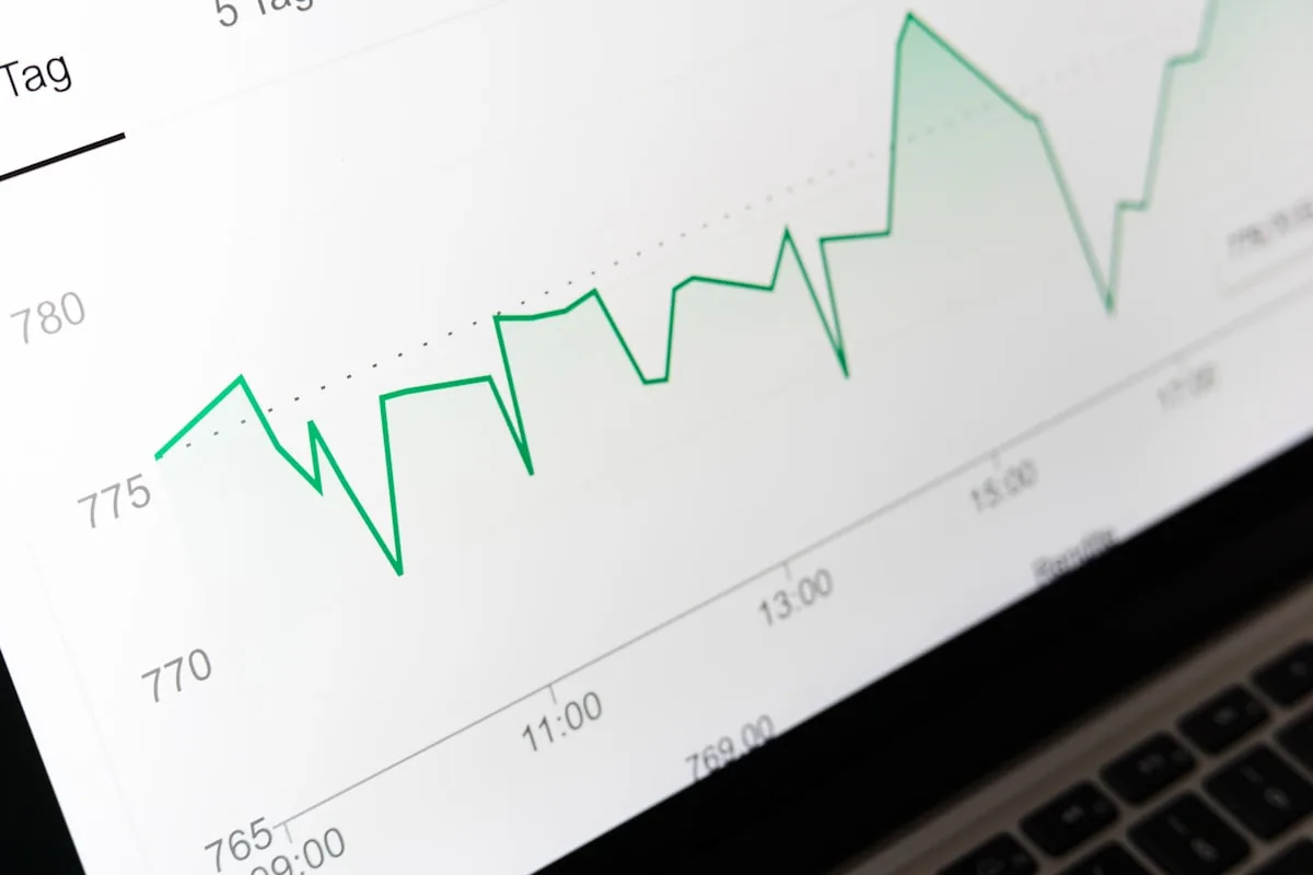 A rising line chart on a laptop screen