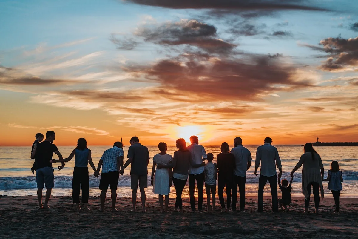 A family on a beach at sunset